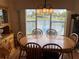 Dining room with large window view to water and lush landscaping at 417 Via Veneto, Venice, FL 34285