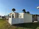 Well-kept home exterior with a privacy fence and additional storage shed at 417 Via Veneto, Venice, FL 34285
