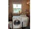 Interior laundry area features washer, dryer, shelving, and a view from the window at 417 Via Veneto, Venice, FL 34285