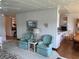 Comfortable living room featuring blue armchairs, offering a seamless flow into other spaces at 417 Via Veneto, Venice, FL 34285