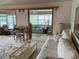 Inviting living room showcasing comfortable seating, a glass coffee table, and view to a sunroom at 417 Via Veneto, Venice, FL 34285