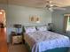 Relaxing main bedroom with a ceiling fan, two side tables, and two framed pictures at 417 Via Veneto, Venice, FL 34285