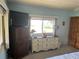 The main bedroom offers a ceiling fan, two windows, dresser and a TV at 417 Via Veneto, Venice, FL 34285