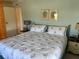 Cozy main bedroom with a framed pictures and lamp on the side tables at 417 Via Veneto, Venice, FL 34285