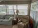 Cozy sunroom with comfortable furnishings and a view of the surrounding landscape at 417 Via Veneto, Venice, FL 34285