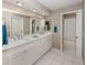 Bathroom features a double sink vanity with white countertops and cabinetry plus a bathtub and shower at 4270 Ascot Dr, North Port, FL 34291