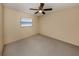 Bright bedroom features a ceiling fan, neutral paint, and window with blinds at 4270 Ascot Dr, North Port, FL 34291
