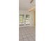 Dining area with neutral colors, tile flooring, and glass doors leading to the outdoors at 4270 Ascot Dr, North Port, FL 34291