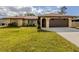 Charming single-story home with stone accents, well-manicured lawn, and a two-car garage at 4270 Ascot Dr, North Port, FL 34291