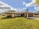 Charming single-story home with stone accents, well-manicured lawn, and a two-car garage at 4270 Ascot Dr, North Port, FL 34291