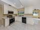 Modern kitchen with white cabinets, stainless steel appliances, and sleek countertops, enhancing functionality and style at 4270 Ascot Dr, North Port, FL 34291