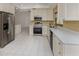 Modern kitchen with white cabinets, stainless steel appliances, and sleek countertops, enhancing functionality and style at 4270 Ascot Dr, North Port, FL 34291