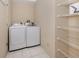 Functional laundry room with washer, dryer, and ample wire shelving for storage at 4270 Ascot Dr, North Port, FL 34291