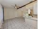 Open-concept living space with a ceiling fan, tile flooring, and seamless flow into the adjacent kitchen and dining areas at 4270 Ascot Dr, North Port, FL 34291