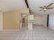 Open-concept living space with a ceiling fan, tile flooring, and seamless flow into the adjacent kitchen and dining areas at 4270 Ascot Dr, North Port, FL 34291