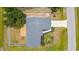 An aerial view shows the home's roof, wooden deck, and backyard in a fenced-in property at 4305 Heyward St, North Port, FL 34291