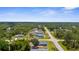 An aerial view of the property showcasing the house, new deck, fenced yard, and neighborhood at 4305 Heyward St, North Port, FL 34291