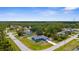 Aerial view of home, landscaped yard, long driveway, and the surrounding neighborhood on a sunny day at 4305 Heyward St, North Port, FL 34291