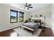 Bedroom boasts modern decor, dark wood floors, and ample natural light at 4305 Heyward St, North Port, FL 34291