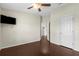 Bedroom featuring hardwood floors, ceiling fan, and access to an adjoining bathroom at 4305 Heyward St, North Port, FL 34291