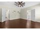Spacious bedroom boasts gleaming wood floors, a modern ceiling fan, and doorways to other rooms at 4305 Heyward St, North Port, FL 34291