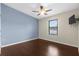 Bedroom with hardwood floors, ceiling fan, and natural light at 4305 Heyward St, North Port, FL 34291