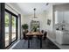 Dining room features a modern light fixture over a wooden table with seating for six at 4305 Heyward St, North Port, FL 34291