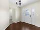 Traditional foyer with hardwood floors features a decorative glass door and chandelier at 4305 Heyward St, North Port, FL 34291