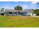 Charming blue single-story home featuring a well-manicured lawn and attached two-car garage at 4305 Heyward St, North Port, FL 34291