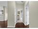 Hallway showcasing the view into an adjoining bathroom, featuring wood floors at 4305 Heyward St, North Port, FL 34291