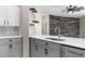Modern kitchen boasts white countertops, gray cabinets, and stainless steel appliances at 4305 Heyward St, North Port, FL 34291