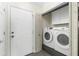 Laundry area with washer and dryer hookups near the entry door and cabinets at 4305 Heyward St, North Port, FL 34291