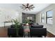 Bright living room with stylish furniture, wood accent wall, and modern ceiling fan at 4305 Heyward St, North Port, FL 34291