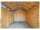 Unfinished storage shed featuring exposed wood frame and concrete floor at 4305 Heyward St, North Port, FL 34291