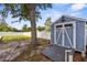 Blue storage shed in backyard featuring double doors and decorative eagle accent at 4305 Heyward St, North Port, FL 34291