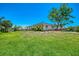 Spacious backyard with large lawn and mature shade tree at 4321 Shamrock Dr, Venice, FL 34293