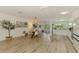 Open-concept dining area boasts plank floors, a modern light fixture, and easy access to the kitchen at 4321 Shamrock Dr, Venice, FL 34293