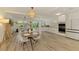 Bright open-concept dining room with a modern light fixture, flows into kitchen with stainless steel appliances at 4321 Shamrock Dr, Venice, FL 34293