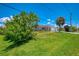 Inviting single-story home with a lush green lawn, enhanced by mature trees and a long driveway at 4321 Shamrock Dr, Venice, FL 34293