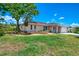 Quaint single-story home featuring a well-manicured lawn, complemented by mature trees and tasteful landscaping at 4321 Shamrock Dr, Venice, FL 34293