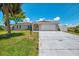 Charming single-story home boasts a two-car garage, concrete driveway, and lush green lawn at 4321 Shamrock Dr, Venice, FL 34293