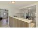 Modern kitchen featuring white cabinets, stainless steel appliances, and a view to the living space at 4321 Shamrock Dr, Venice, FL 34293