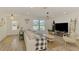 Inviting living room with plank floors and neutral decor offers comfortable seating and lots of natural light at 4321 Shamrock Dr, Venice, FL 34293
