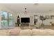 Cozy living room boasts plank floors, a comfortable sofa, and a large window that fills the space with natural light at 4321 Shamrock Dr, Venice, FL 34293