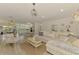 Spacious living area with open concept shows plank floors throughout to the dining area and kitchen at 4321 Shamrock Dr, Venice, FL 34293