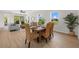 Bright dining area featuring a rustic table and comfortable seating near the living room at 4390 Asteria Ter, North Port, FL 34287