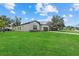 Well-maintained home with a lush green lawn and a view of the neighborhood at 4390 Asteria Ter, North Port, FL 34287