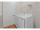 Laundry area with appliances, storage shelf, and door at 4390 Asteria Ter, North Port, FL 34287