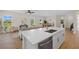 Bright living area featuring an open floor plan that connects the kitchen with the living and dining spaces at 4390 Asteria Ter, North Port, FL 34287