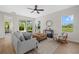 Cozy living room with a comfortable sofa, natural light, and access to outdoor space at 4390 Asteria Ter, North Port, FL 34287